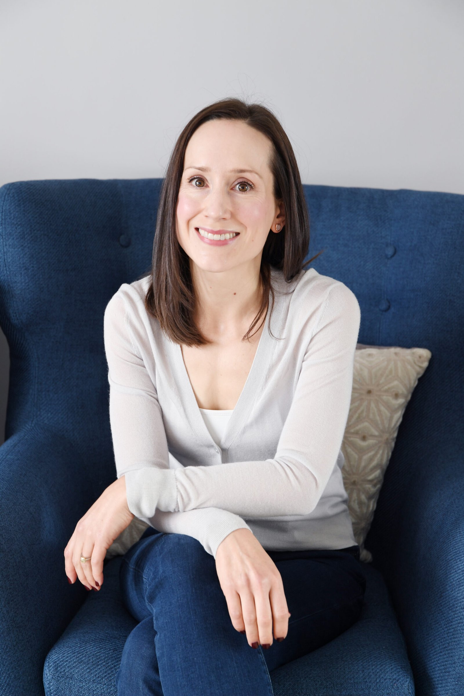 Woman sitting in a chair looking happy and confident